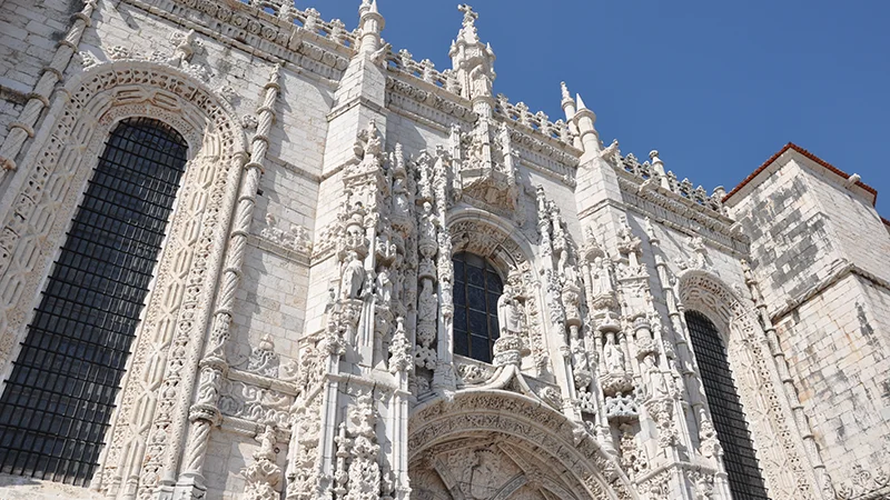 The long carved facade of the Jeronimos Monastery in Lisbon