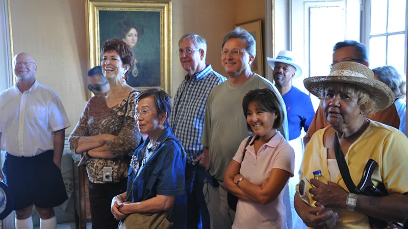 Visitors moving through a state room at Queluz Palace