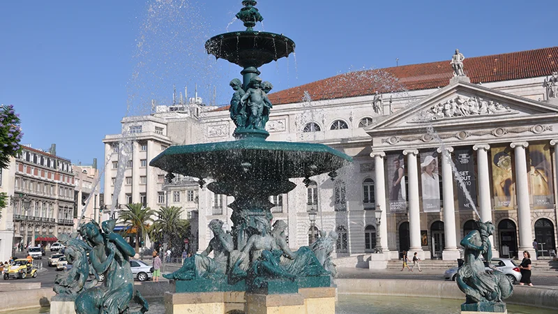 Fountain in Rossio square with the National Theatre behind it
