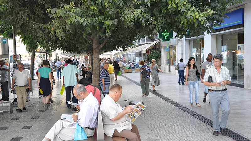 Pedestrians crossing Rossio square in Lisbon