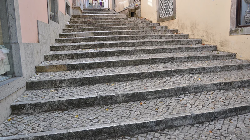 Broad stone staircase climbing through the town of Sintra