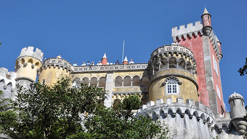 Pena Palace at Sintra with its blue and yellow towers above the trees