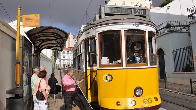 Yellow Lisbon tram waiting at a stop