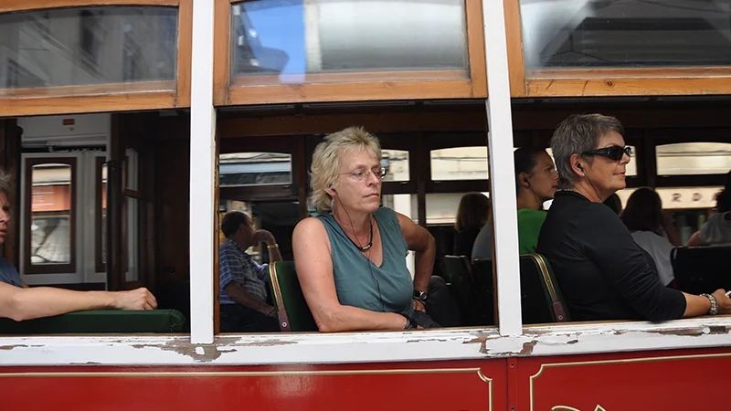 Interior of a Lisbon tram with passengers seated