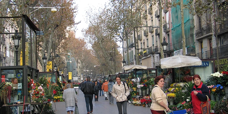 La Rambla pedestrian promenade bustling with visitors and lined with trees