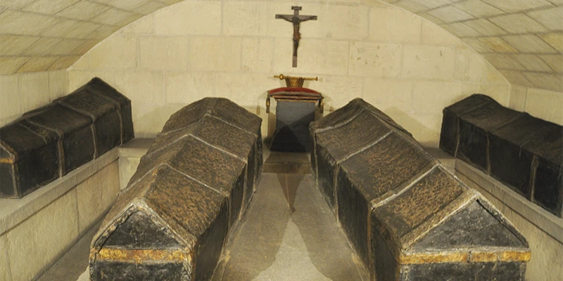 The lead coffins of Ferdinand and Isabella visible through the crypt grille