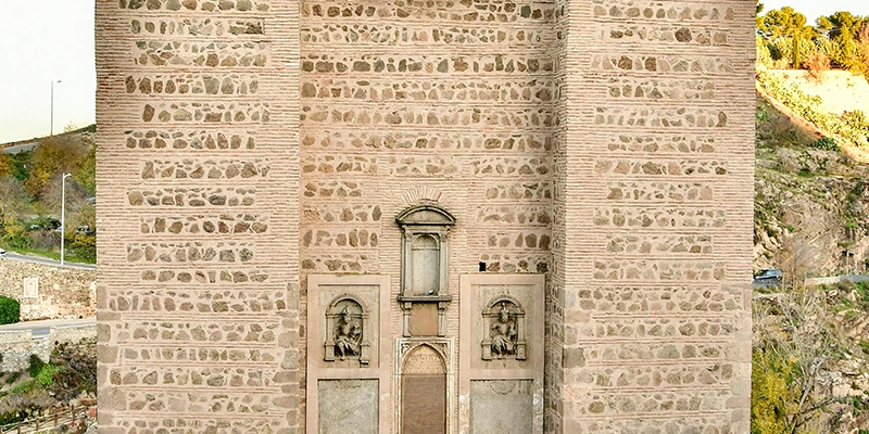 Puerta de Bisagra, the main ceremonial gate to Toledo with twin towers and Habsburg eagle