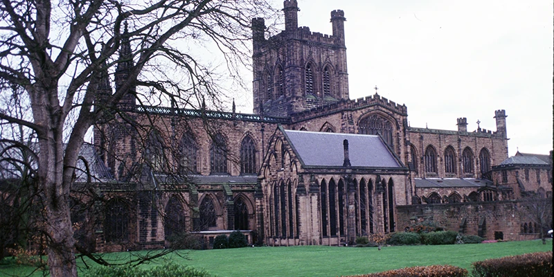 Chester Cathedral and its lawn seen through bare winter trees