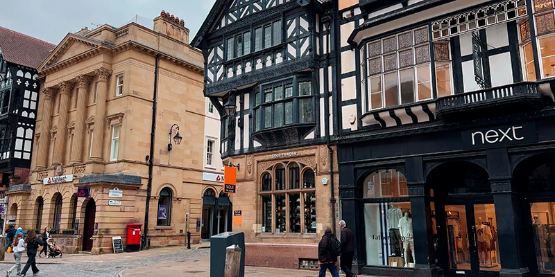 Mixed classical and half-timbered shopfronts on a Chester street