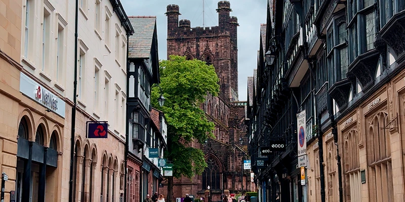Narrow Chester street lined with timbered buildings