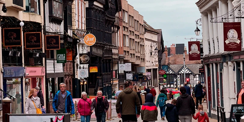 Pedestrians on a Chester shopping street closed to cars