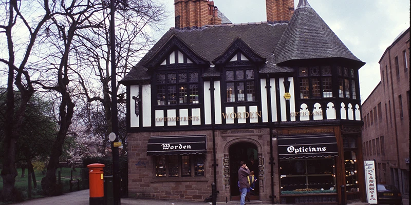 Timber-framed shopfront in Chester with a red telephone box outside
