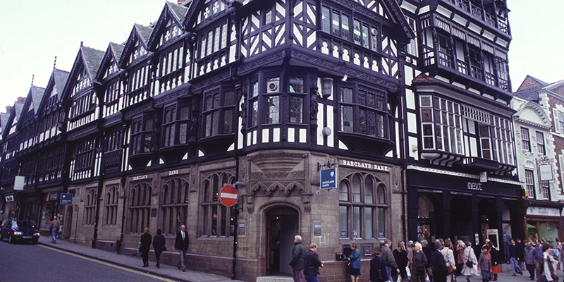 Half-timbered corner building in Chester lit in the evening