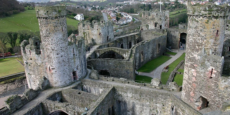 The interior of Conwy Castle from the battlements, with the countryside beyond