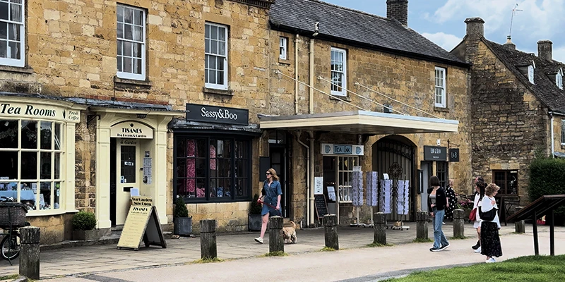 Tisanes Tea Rooms with cream-painted facade, alongside Sassy and Boo and Tea Ink shops