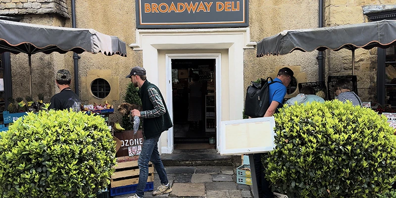 The Broadway Deli entrance with awnings and crates of fresh produce outside