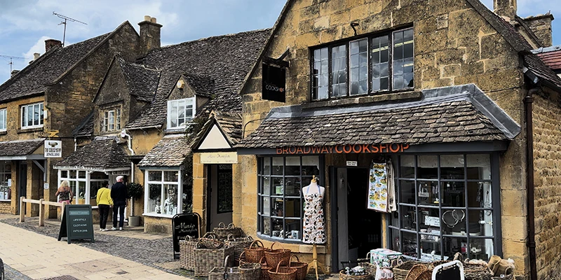 Broadway Cookshop with baskets outside and an apron displayed in the window