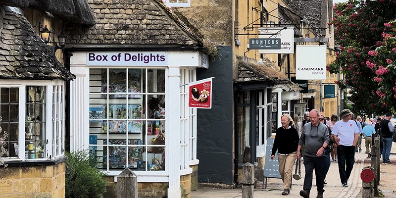 Visitors strolling past the Box of Delights shop on Broadway High Street