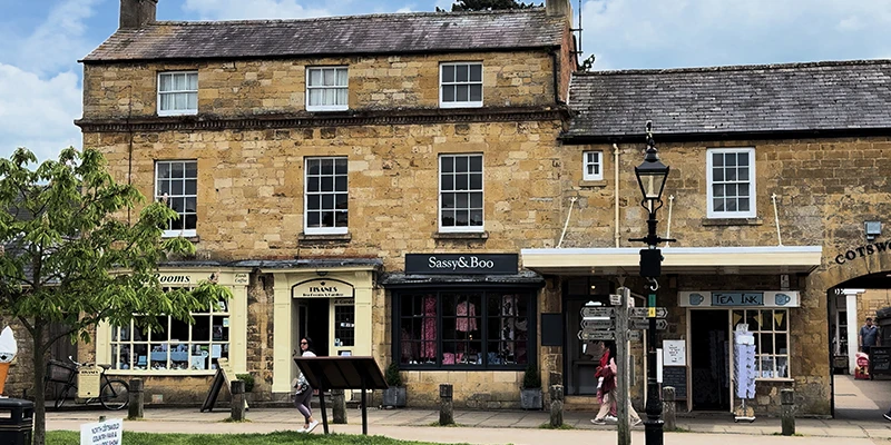 Visitors strolling past Sassy and Boo clothing shop along the High Street