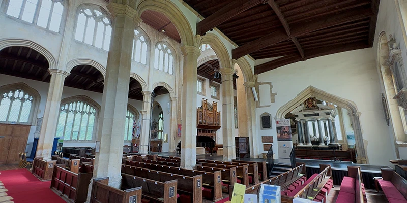 St. James Church interior with stone arches and stained-glass windows