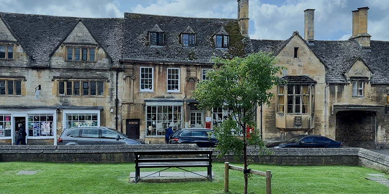 High Street view across the green with bench and trees