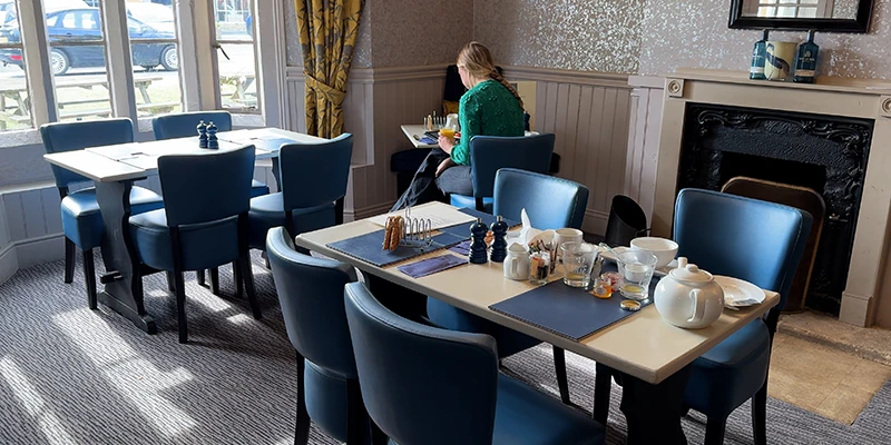 Hotel breakfast room with diner and tea service