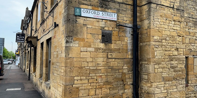 Oxford Street sign on stone wall, Black Bear pub