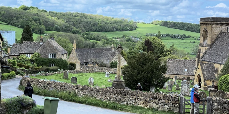 View from the lane showing cottages, churchyard, and surrounding valley