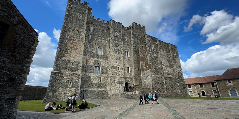 The Great Tower at Dover Castle with visitors in the inner bailey