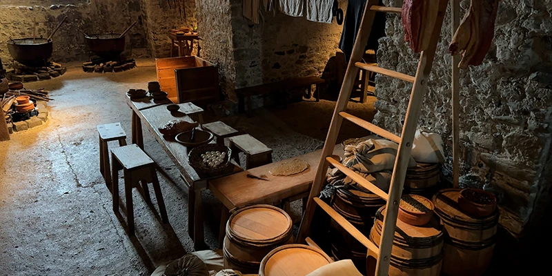 The re-created medieval kitchen at Dover Castle with pots and barrels