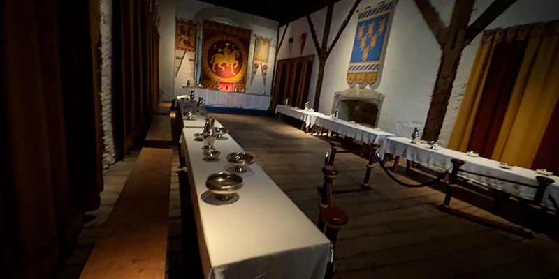 Long table with candles and pottery in a service room at Dover Castle