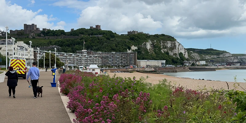 The Dover seafront promenade with flower beds and the castle above