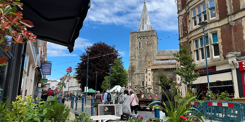 Dover street with the church tower and market stalls beyond