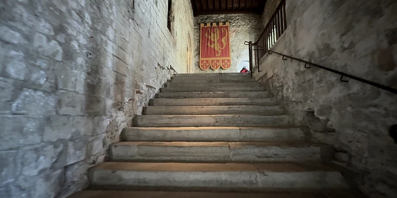 Stone staircase leading up to a red door inside Dover Castle