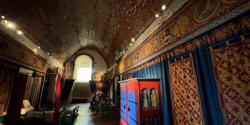 Candlelit chamber at Dover Castle with painted decoration