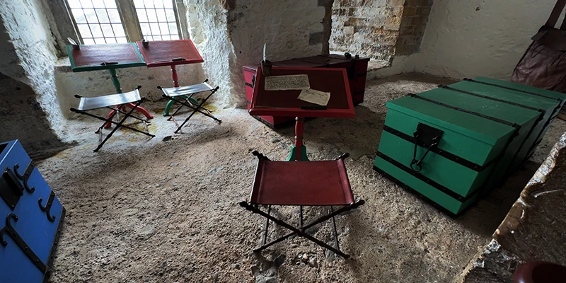 Camp beds and storage chests in a chamber at Dover Castle