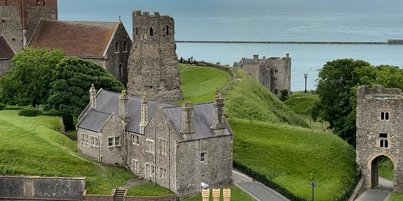 View across the grounds of Dover Castle to the church and Roman lighthouse