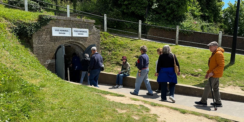 Visitors walking the path outside the walls of Dover Castle