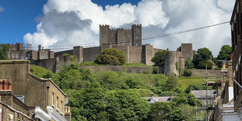 Dover Castle above the rooftops seen from a town street