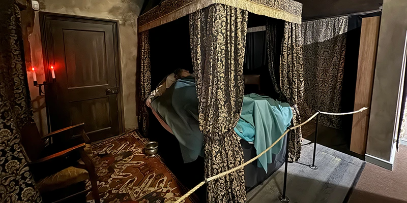 A curtained bedchamber inside Oliver Cromwell's House