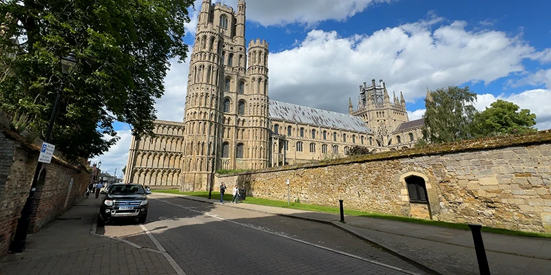 The west tower of Ely Cathedral rising above the precinct wall