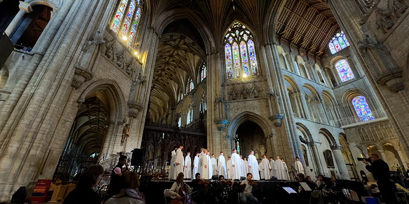 A choir performing in the nave of Ely Cathedral