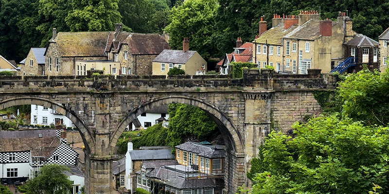 A viaduct arch framing the houses climbing the gorge at Knaresborough