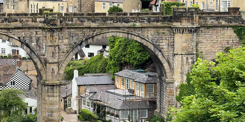 The stone arches of the viaduct rising above the rooftops of Knaresborough