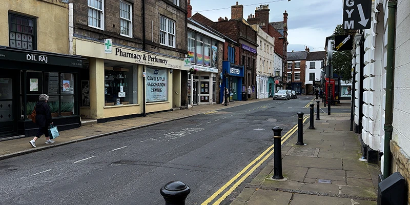 The pharmacy and shops on a street off the Market Place in Knaresborough