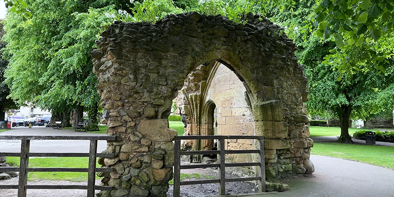 A stone archway among the castle ruins in the grounds at Knaresborough