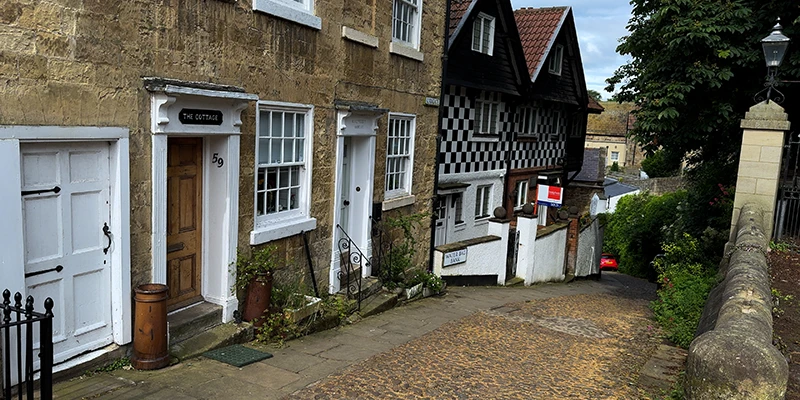 A timbered house at the bend of Kirkgate above the river