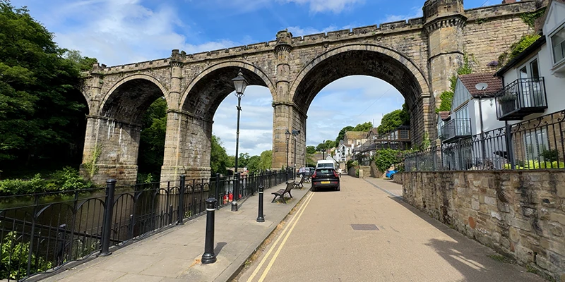 The Knaresborough viaduct arching over the riverside road