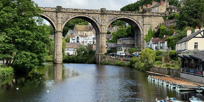 The Knaresborough viaduct reflected in the still water of the River Nidd