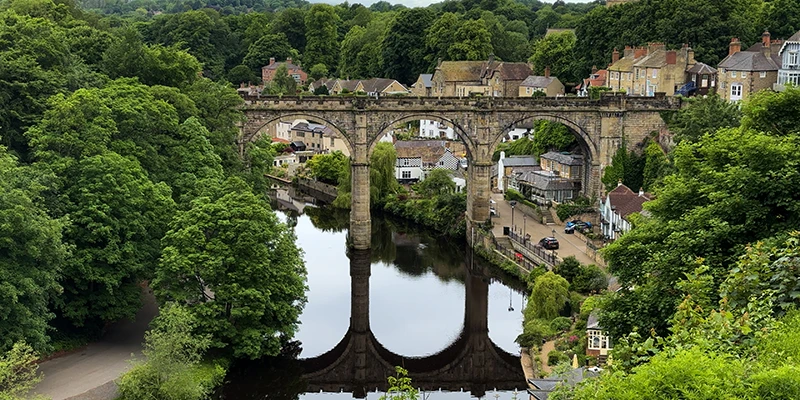 The Knaresborough viaduct seen through the trees of the gorge